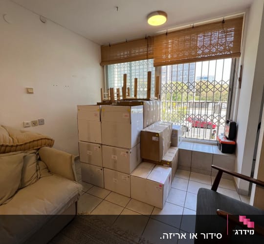 קופסאות ארוזות בחדר עם חלון גדול